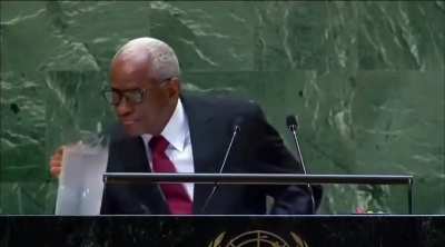 The President of haiti drinking a cup of water during his UN General Assembly speech