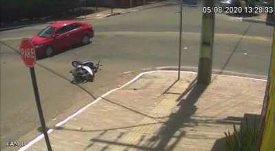 Biker crashes into car and falls into sewage