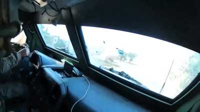 Ukrainian soldiers in a Kozak-7 take small arms fire from Russian forces on the streets of Selydove