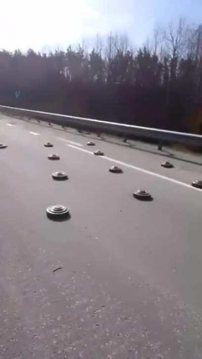 Ukrainians are driving across a mined road