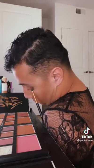 Man without limbs does his makeup