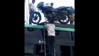 How this guy puts a motorbike on a bus