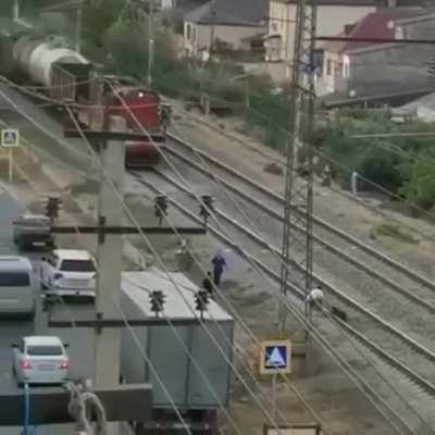 Drunk guy pulled off tracks by bystanders in Dagestan, Russia