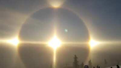 Sun rays refracting through ice crystals in air