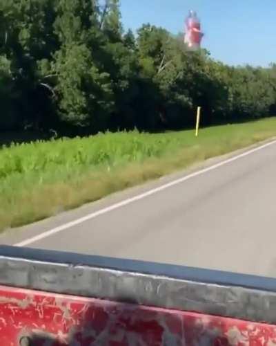 Aerodynamic drag pulling this plastic bottle behind a pick up truck