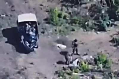 Ukrianian drone films russian soldiers carrying there dead to a truck 