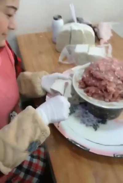 This woman wraps Wontons almost faster than I can watch.