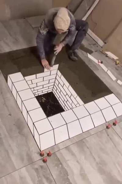 This dude working on a bathroom floor