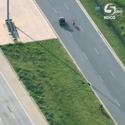 Cowboys wrangling a cow loose on OKC highway