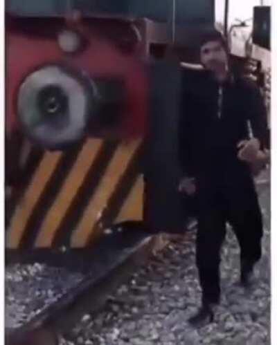 Dude gets thwacked on the head by an oncoming train