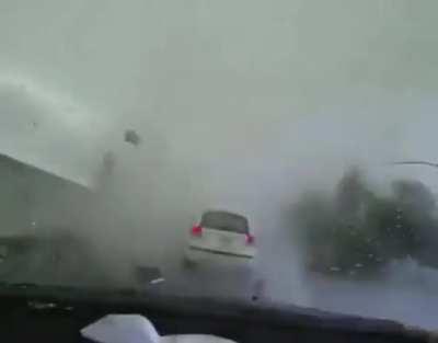 Tornado forms on a car while driving.