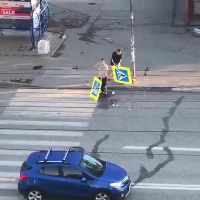 Russians upset at a blue and yellow crosswalk sign....