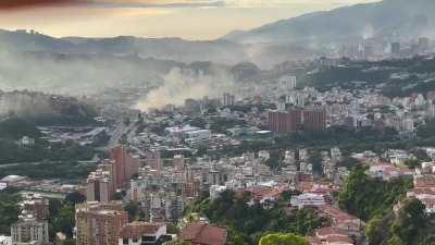 Venezuelan journalist Titi González shows a panoramic view of western Caracas -once a stronghold of Chavismo- full of smoke from the spontaneous protests and subsequent clashes