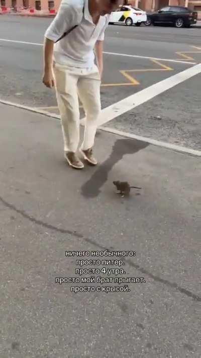 A dude jumping with a rat