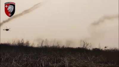 A pair of Ukrainian helicopters attacking Russian positions with indirect rocket fire is filmed by soldiers of the 63rd Mechanized Brigade somewhere in the Donbas region, April 2024