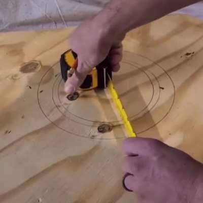 Drawing a circle with a tape measure and a nail