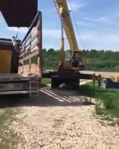 Man crushed by a container while standing on a truck