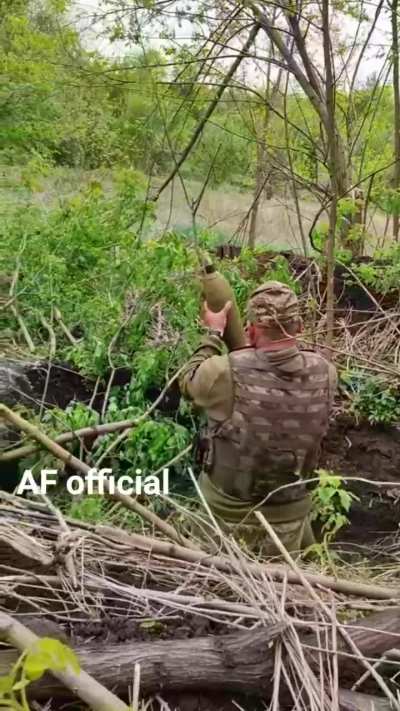 A Ukrainian mortar team fires a 120mm round at Russian targets.