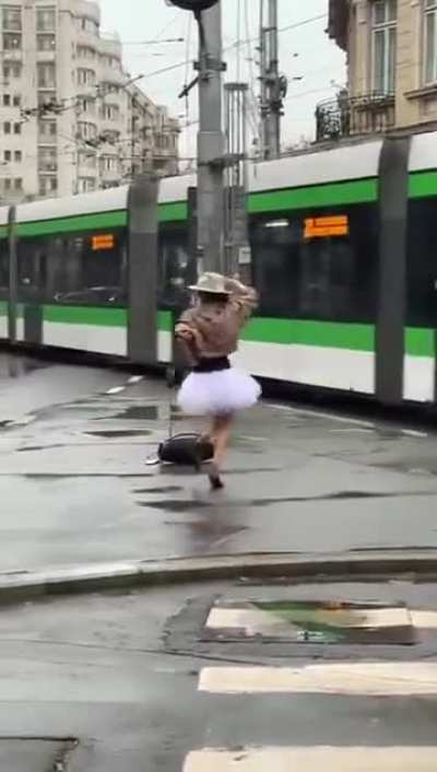 Woman dancing in the rain in Bucharest, Romania 