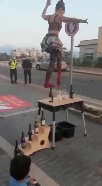 Women performs incredible balancing test on bottles