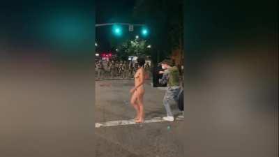 Portland police retreat after standoff with naked female protester reupload