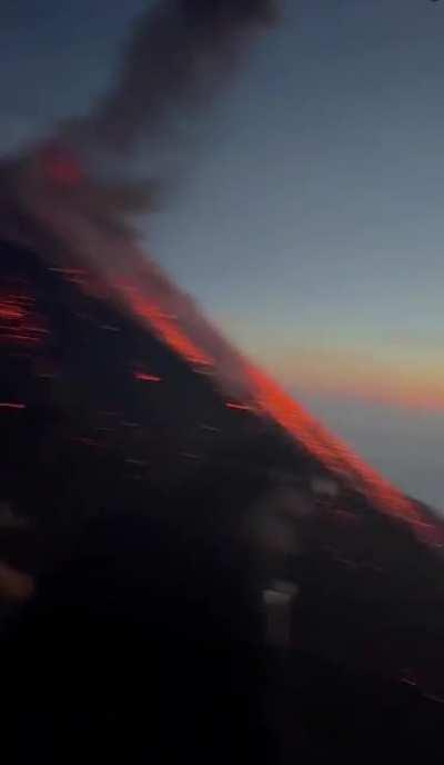 Group films active volcano while standing on it