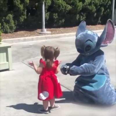 Little girl falls so Stitch does too