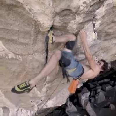 Pro climber uses a 'Knee-Bar' to bring blood back to his forearms.