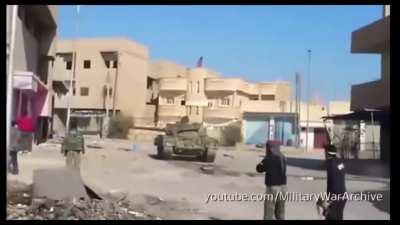 An ISIS tank pulls into an intersection to take a few shots, only to be hit by an ATGM. (Date/location Unknown)