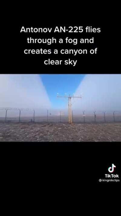 Plane flies through fog revealing the clear sky