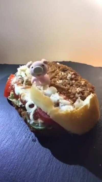 Lil piggy devouring a sandwich