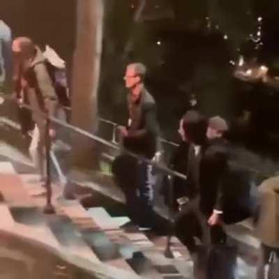 Keanu Reeves helping the crew of John Wick 4 move equipment around.