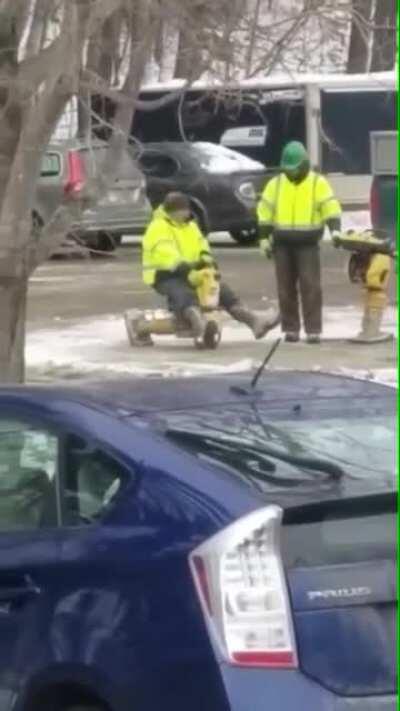 A construction worker riding a “wacker” compactor