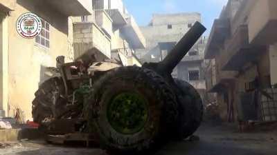 FSA &quot;Hell Cannon&quot; team deals with a sandbagged firing position by destroying the building around it - Masaken al-Sabeel neighborhood, Aleppo - 2015