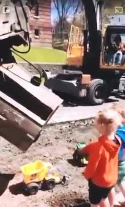 Bagger machine operator takes a minute to bring some smiles for kids