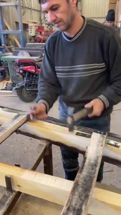 The way this guy bangs the nails into the wood 