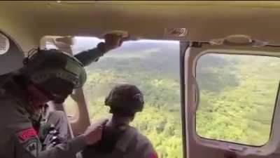 Aerial firing by Indonesian Police Mobile Brigade Corps towards Papuan rebels during operation to evacuate head of Papua representative of National Human Rights Commission.
