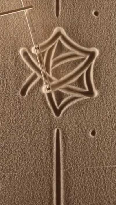 A Hand drawn geometric Art on sand...