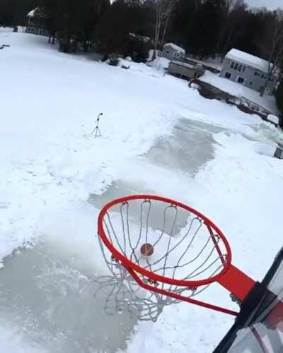 Guy on ice plays some basketball.