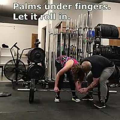 This gym instructor is teaching a blind woman how to lift weights