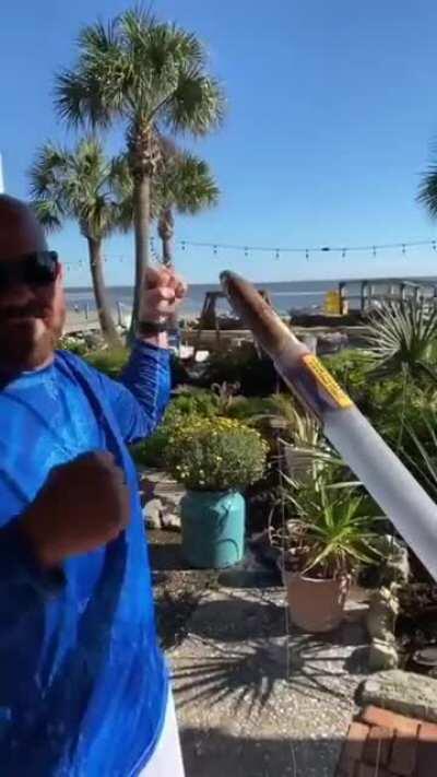 man makes a launcher for fishing rod.