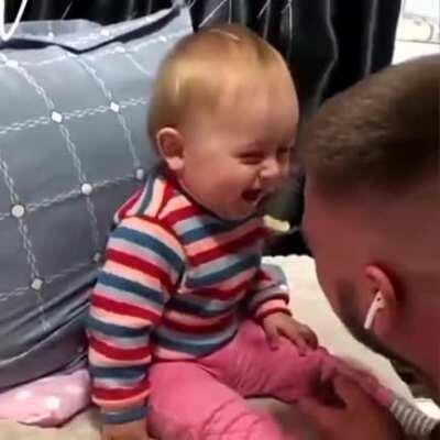 Dad tries to feed baby but both can't stop laughing