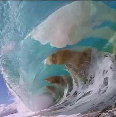 The way the sand moves with the waves.