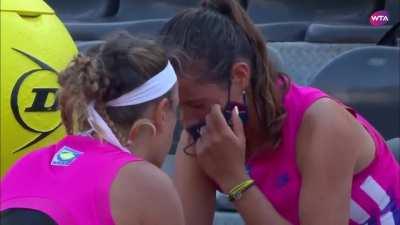 Tennis player Azarenka consoling her opponent after she twisted her ankle and forced to retire.