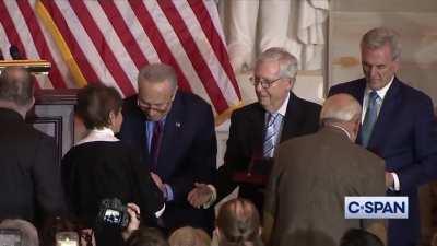 During Congressional Gold Medal ceremony for Jan. 6 police, representatives of those receiving awards shake hands with Schumer then walk past McConnell and McCarthy.