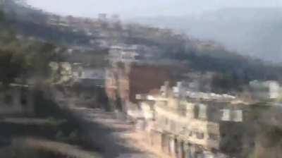 SyAAF planes use parachute-retarded bombs on Opposition controlled homes near al-Hosn Castle - 1/4/2013