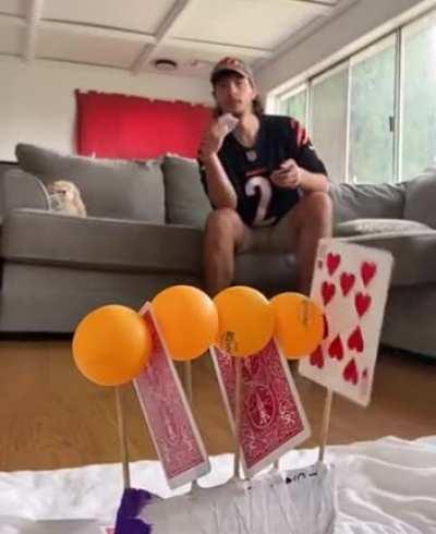 Throwing cards between ping pong balls