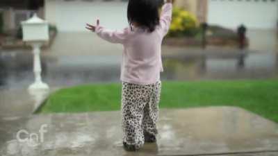 Little girl experiences rain for first time.