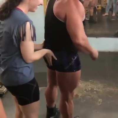 Guy lets girl at the gym feel his muscles, it puts the biggest smile on her face