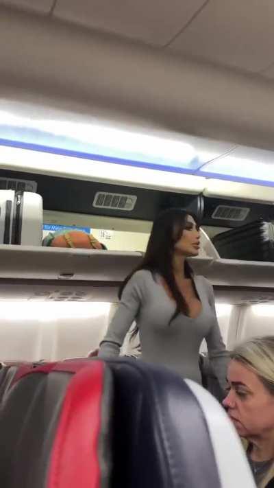 Women becomes very rude with other passengers on an airplane. 